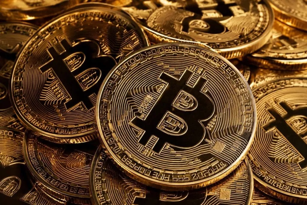 Bitcoin wallet icon and an AI chatbot on a computer screen