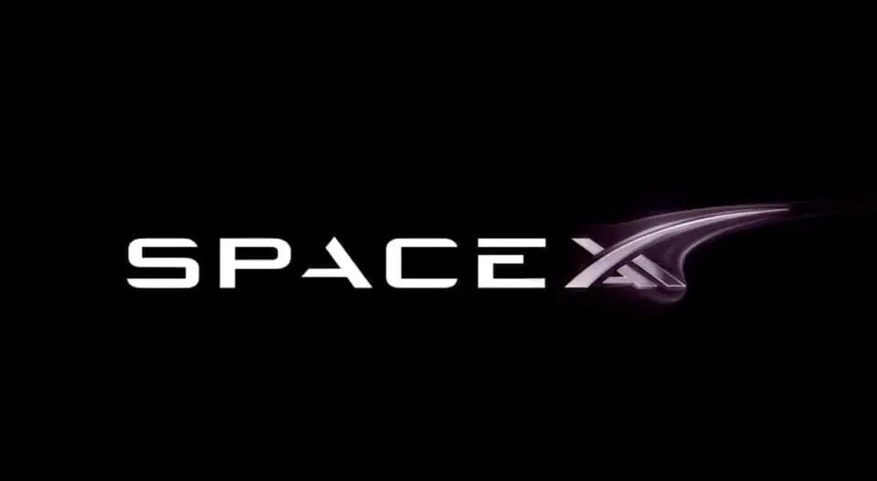 Robot typing at a laptop running an AI code editor for SpaceXAI